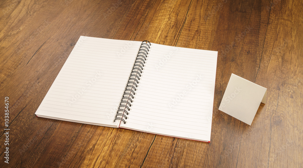 Note book on a wooden desk Note book on a wooden desk