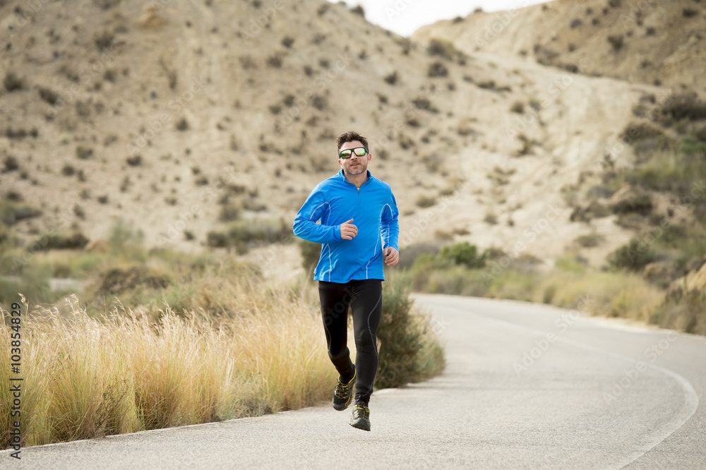 sport man running on dry desert landscape in fitness healthy lifestyle