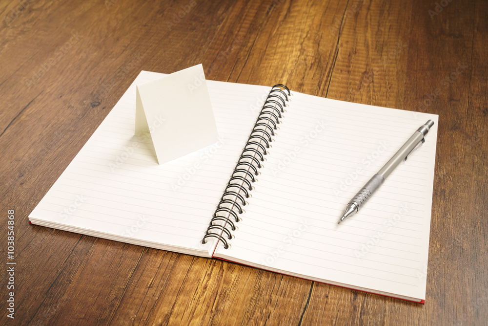 Note book with pencil on a wooden desk Note book with pencil on a wooden desk