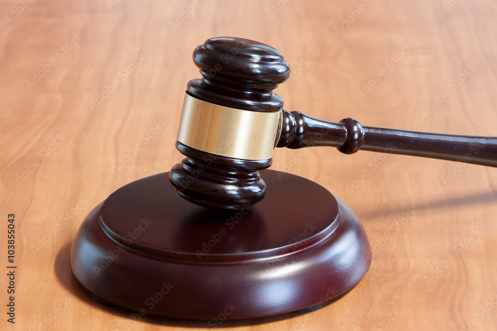 Judicial hammer on a wooden table Judicial hammer on a wooden table