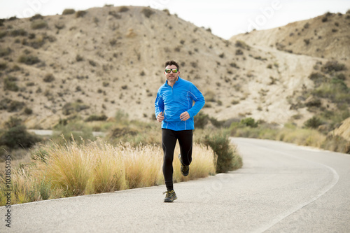 sport man running on dry desert landscape in fitness healthy lifestyle