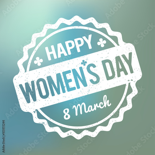 Happy Women's Day rubber stamp white on a blue bokeh fog background.