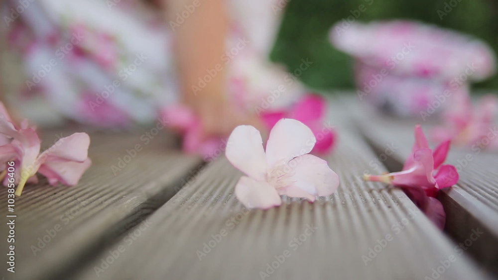 Children's hands picking flowers on the wooden floor Children's hands picking flowers on the wooden floor
