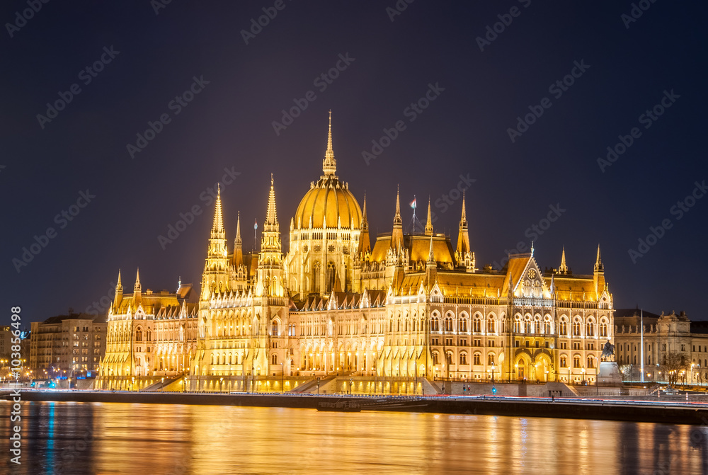 Night view of the Hungarian Parliament Building on the bank of the Danube in Budapest, Hungary.