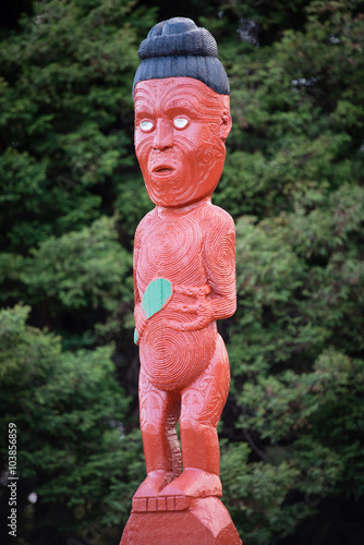 Traditional Maori carving sculpture of a man in Rotorua park, North Island, New Zealand