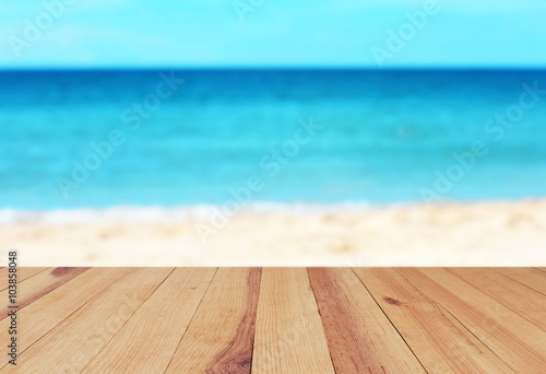 Wood table on blurred beach background