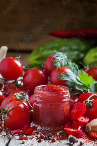 Tomato ketchup hot sauce with chili pepper and cherry tomatoes i