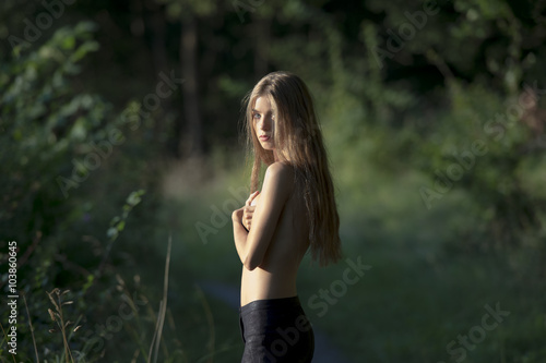 Canvas Print girl in black leggings standing in the woods