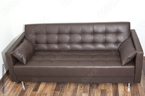Brown leather sofa in room