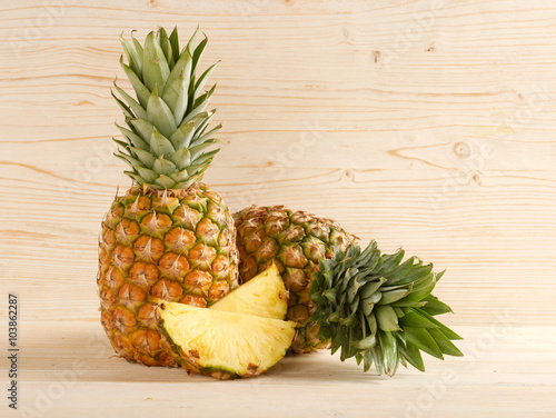 pineapple on a wooden background © lenkaprusova