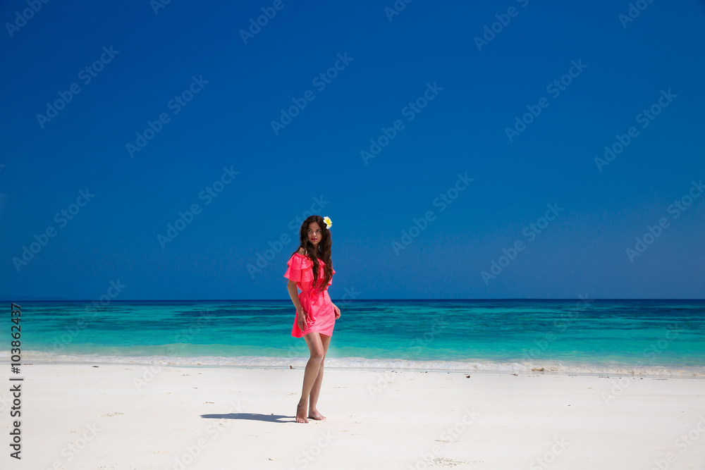 Beautiful woman walking on exotic beach, brunette girl model in
