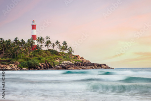 Lighthouse on the cliff in Kovalam Beach © gilitukha