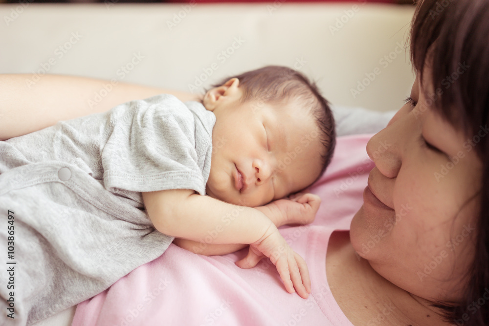 Asian mother holds her newborn baby Asian mother holds her newborn baby