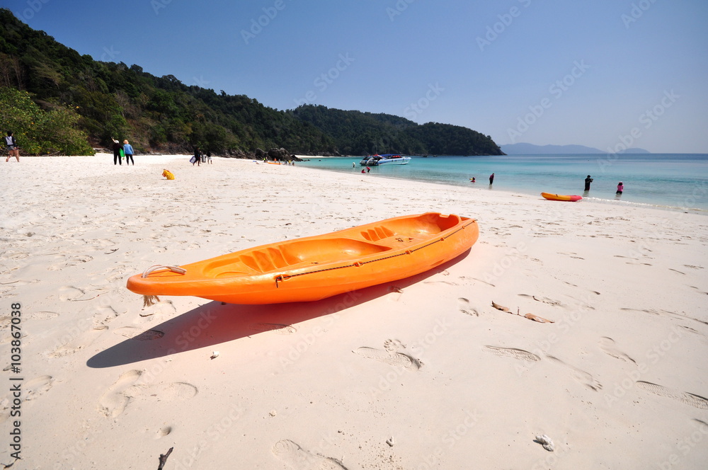 Old Orange boat on white beach on warm sunset. Old Orange boat on white beach on warm sunset.