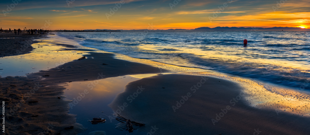 Colorful sunset over the Pacific Ocean at Wreck Beach in Vancouver, BC