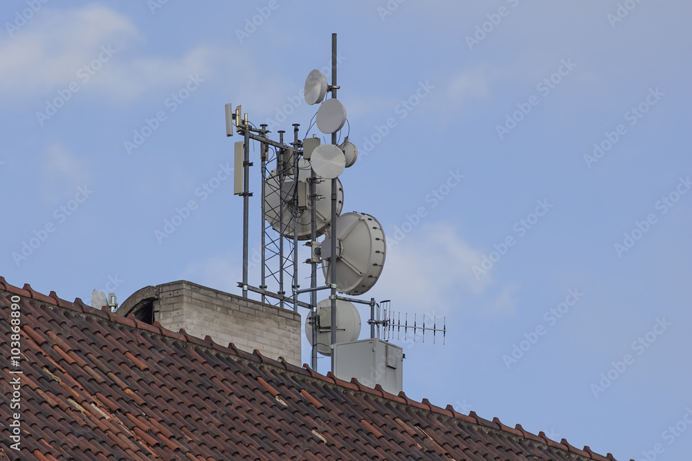 Different kinds of antennas on a roof of historical building Different kinds of antennas on a roof of historical building