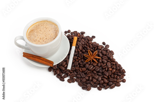 A cup of coffee with cinnamon, sugar and star anise