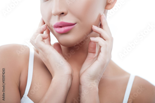 Cheerful healthy woman is caring of her skin