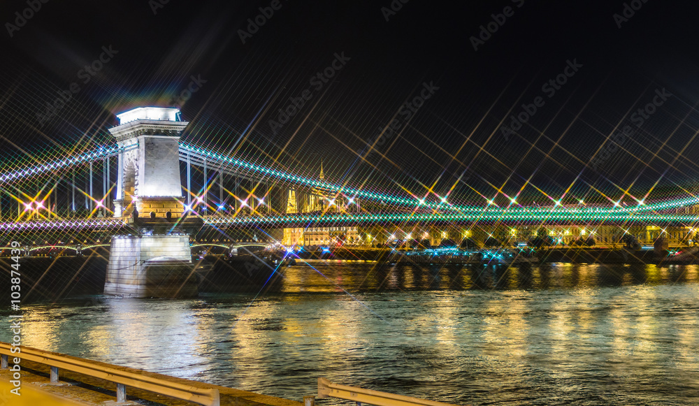 Night view on Szechenyi Chain Bridge over Danube river in Budapest, Hungary. Cross Filter Effect