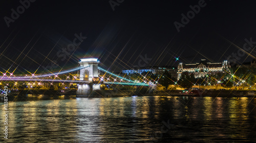 Night view on Szechenyi Chain Bridge over Danube river in Budapest  Hungary. Cross Filter Effect