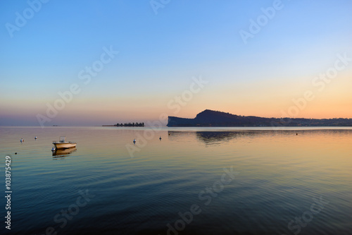 Reflections at sunset on lake Garda