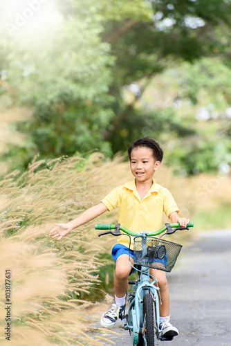 Boy riding bicycle on the road.