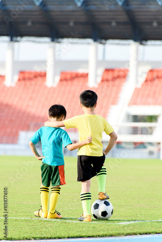 Boy and football in the football grass field