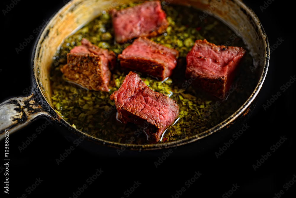 a piece of steak in green sauce a piece of steak in green sauce