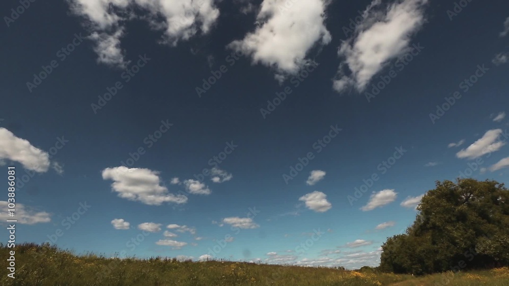 Timelapse clouds over the green field