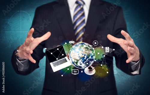 Business person holding laptop and globe