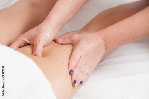 Masseur makes anti-cellulite massage young woman