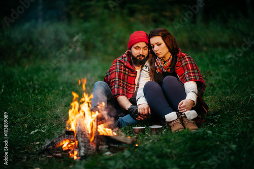 lovers around the campfire at night