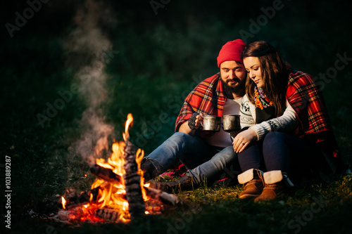 lovers around the campfire at night