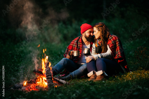 lovers around the campfire at night
