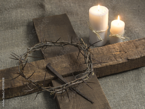 Top view of a holy cross, crown of thorns and candles on a burla