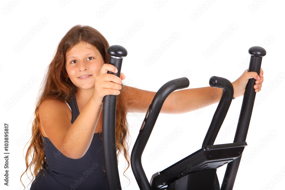 Little girl with elliptical trainer Little girl with elliptical trainer