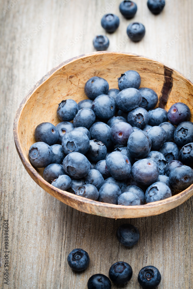 Blueberries in a bowl on a wooden table. Blueberries in a bowl on a wooden table.