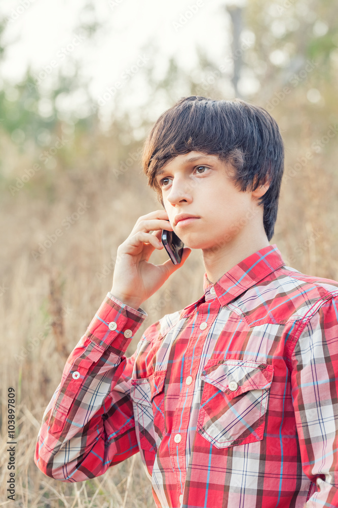 young student talking on mobile phone in a city park young student talking on mobile phone in a city park