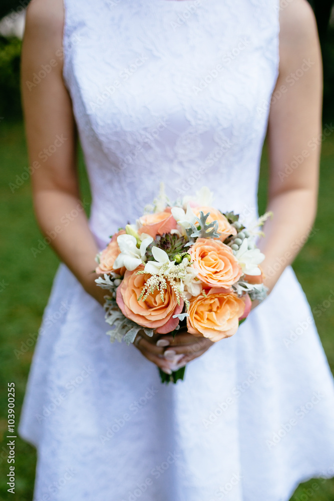 Bride with a beautiful bouquet of roses in her hands Bride with a beautiful bouquet of roses in her hands