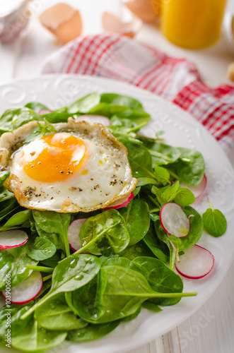 Fresh spinach, radish salad with fried egg