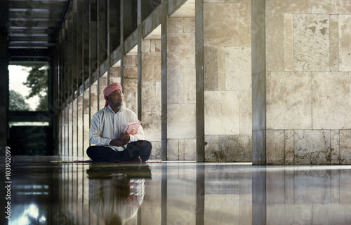 Religious muslim man reading holy koran © Leo Lintang