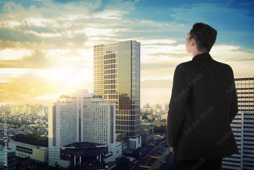 Back view of asian business man looking the sky Back view of asian business man looking the sky