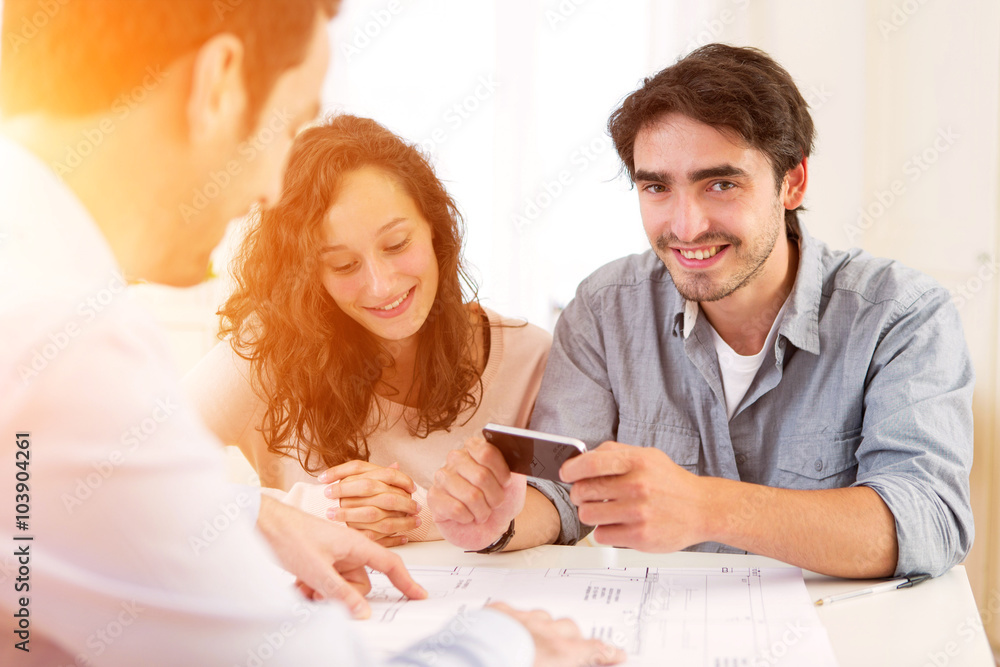 Fototapeta premium Young attractive couple signing contract