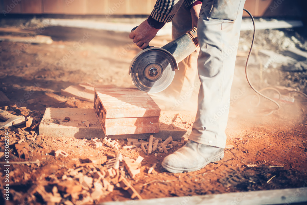 worker using an angle grinder on 