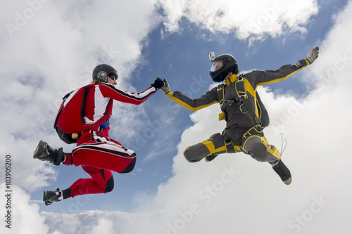 Two parachutists girls in free fall.