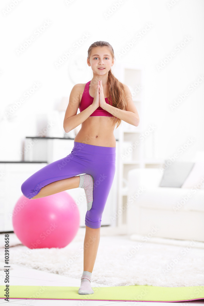 Young girl making fitness exercise indoors Young girl making fitness exercise indoors