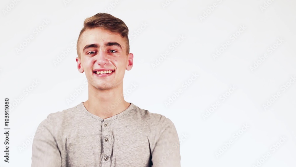 Handsome guy showing heart. Man smiling standing on a white background.