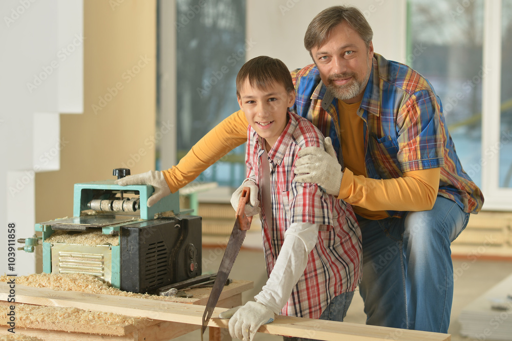 Fototapeta premium father and little boy repairing in the room