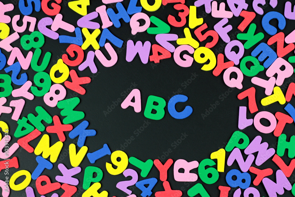 Fototapeta premium Colorful letters and numbers on black background.