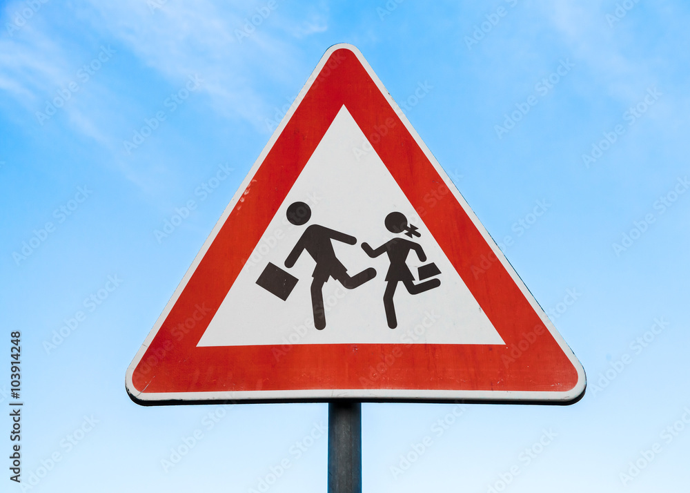 Road sign caution children over blue sky Road sign caution children over blue sky